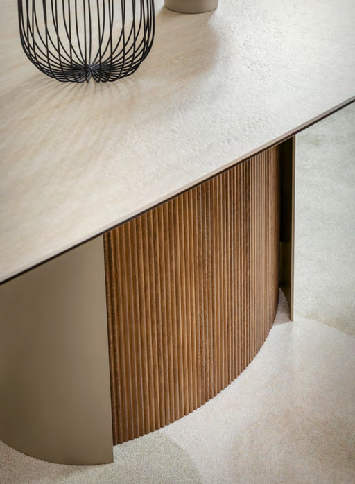 A modern Calligaris furniture piece featuring a sleek beige marble top with decorative black wire accents, complemented by a curved wooden slatted cabinet and soft beige carpet flooring.