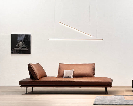 Minimalist living room featuring a luxurious Cierre Imbottiti Italian leather sofa with sleek design, brown leather upholstery, and modern decor accents.