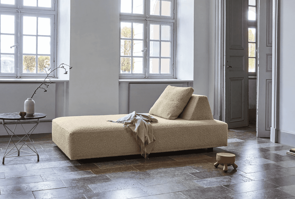 Single-sided Eilersen Playground Sofa in cream boucle with one backrest repositioned, showcasing its flexible Danish design.