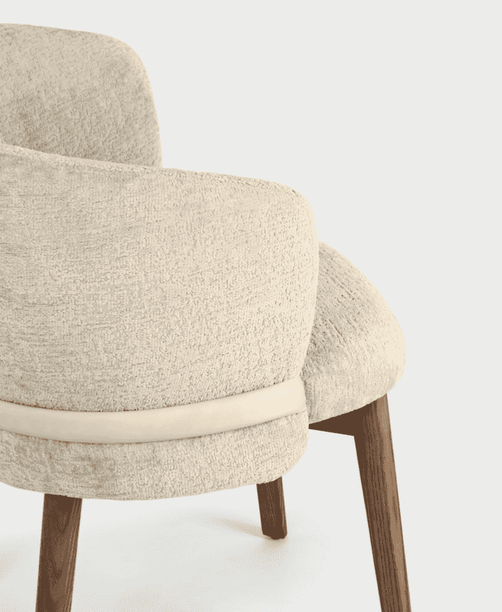 Close-up of CS2238 Vanilla Dining Chair with Wood Legs by Calligaris.com, showing textured upholstery and curved backrest for comfort.