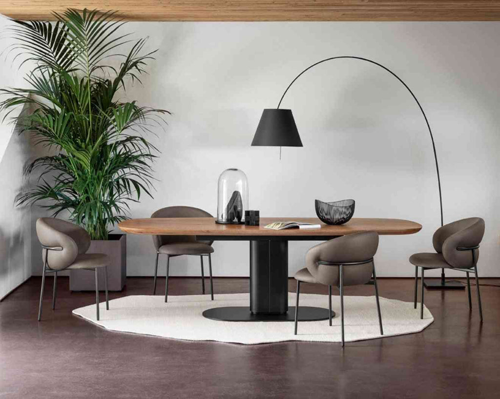 Modern dining room with a round table, chairs, and a tall floor lamp.