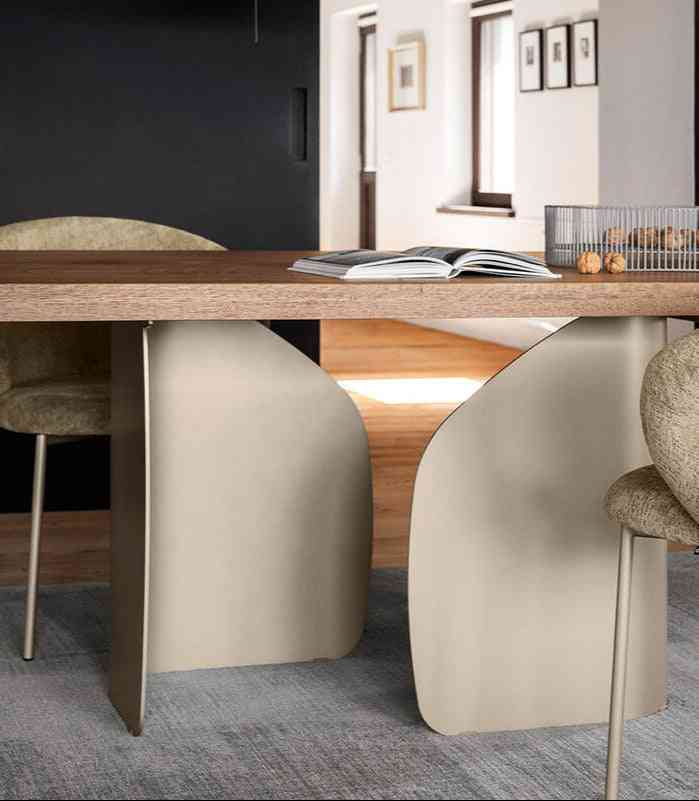 Close-up of a wooden dining table with a wider shot of a dining room setup.