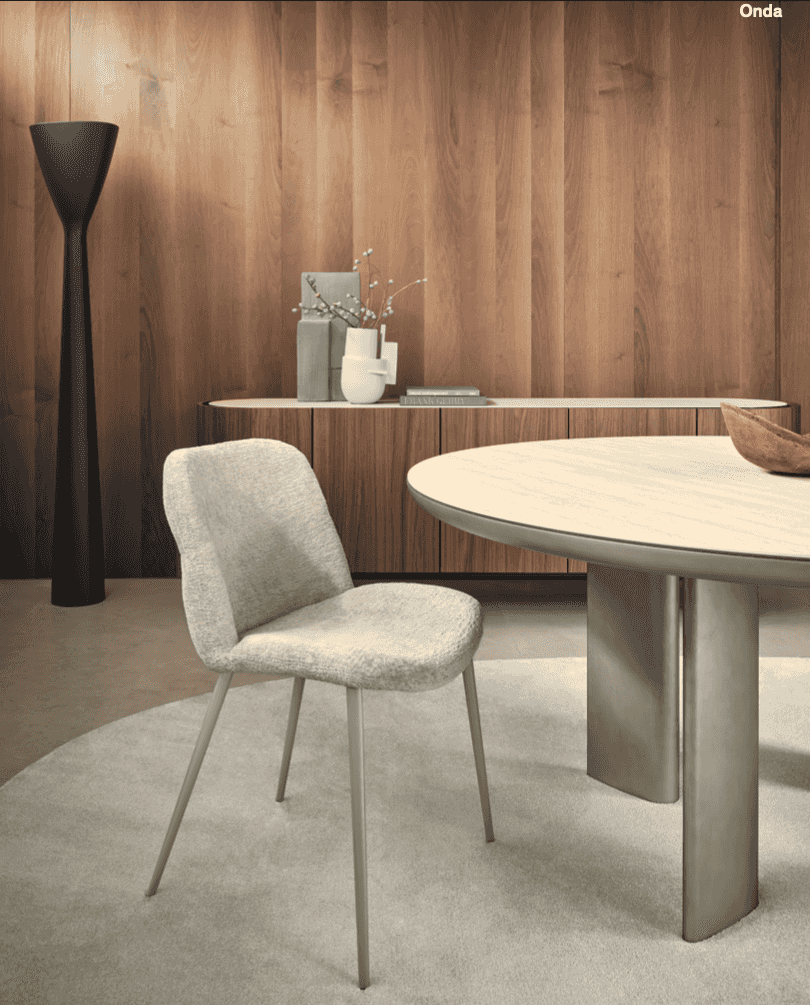 Light fabric version of the CS2239 Onda Dining Chair by Calligaris in a minimalist dining space with wood accents and neutral tones.
