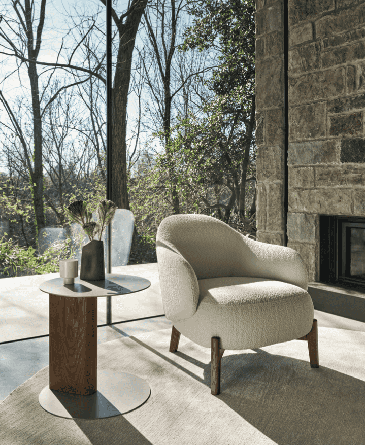 CS3463 Holly Fab Lounge Chair by Calligaris in a modern glass-walled room, paired with a round side table and natural outdoor view.