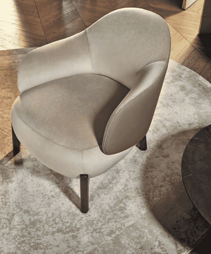 CS3463 Holly Fab Lounge Chair by Calligaris in beige velvet finish, placed on a round rug in a stylish interior with wood flooring.