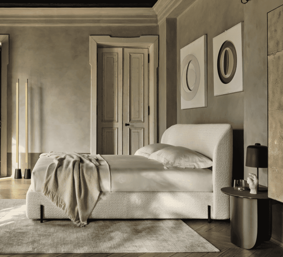 Side view of CS6217 Rendez Vous Bed by Calligaris Italy in a refined bedroom, highlighting its soft curves and contemporary platform frame.
