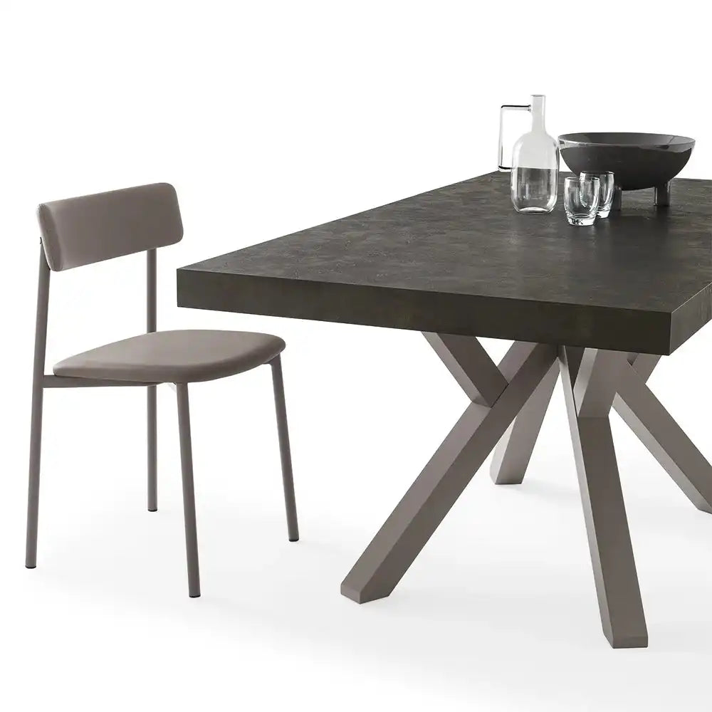 Dark stone dining table with a sleek, rectangular surface and matching modern chair, set in a contemporary dining space