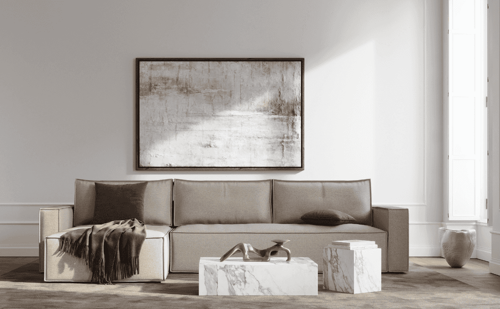 Elegant living room with a beige sofa bed, abstract artwork, wooden furniture, and soft lighting, cozy and stylish ambiance