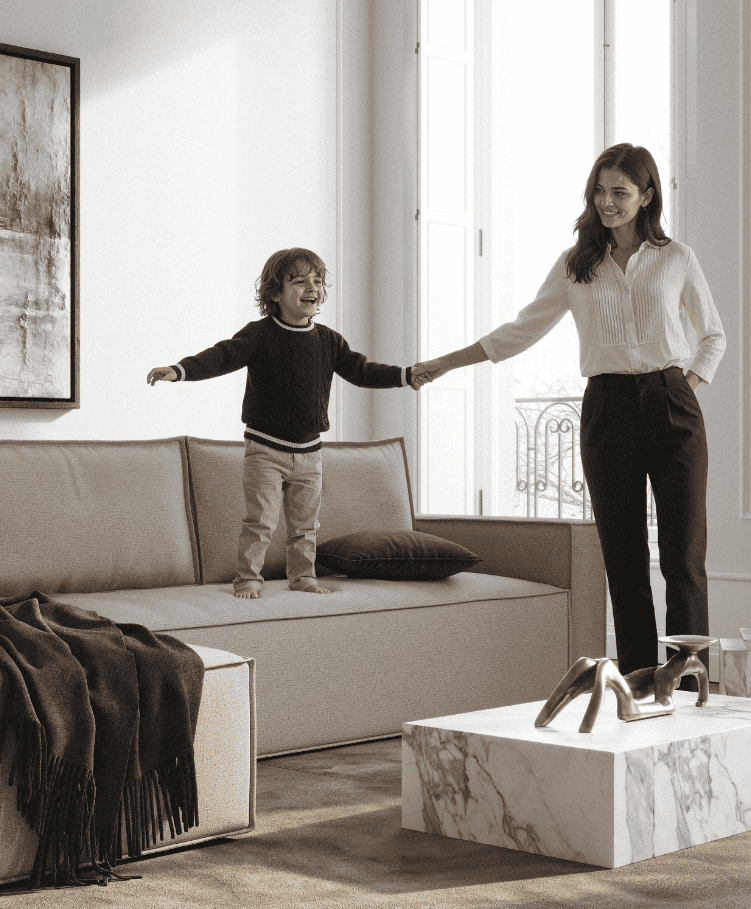Living room with a beige sofa bed in performance fabric, a woman and child playing, large window, modern decor, SKU: 95-543150257-01-2