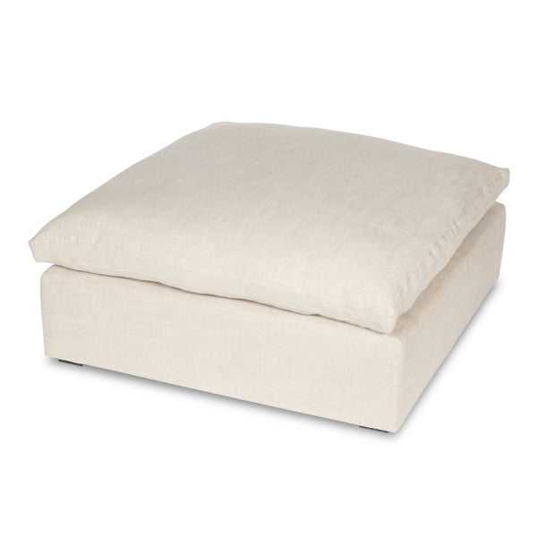 Soft beige ottoman with plush cushion, versatile for footrest or additional seating in a modern living room