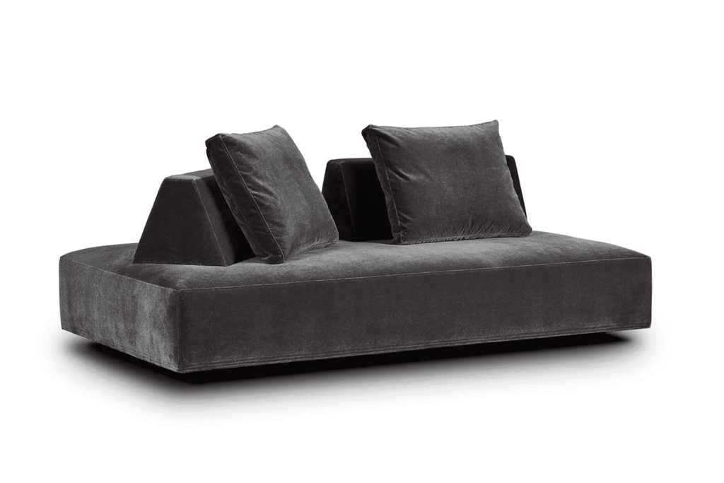 Angled view of Eilersen Playground Sofa in dark grey velvet, showing its double-sided seating and sculptural backrests.