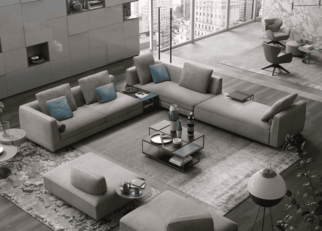 Modern living room with large gray sectional sofa, multiple cushions, and sleek coffee table, stylish and comfortable furniture setup