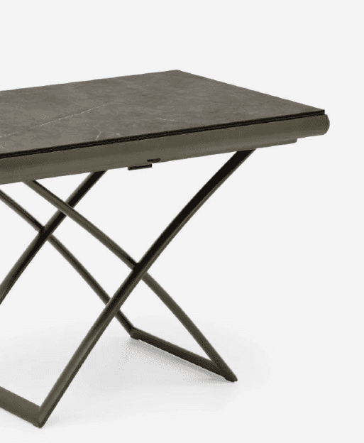 Close-up of a modern coffee table with a marble top and metal X-shaped base, showcasing sleek design and durable materials
