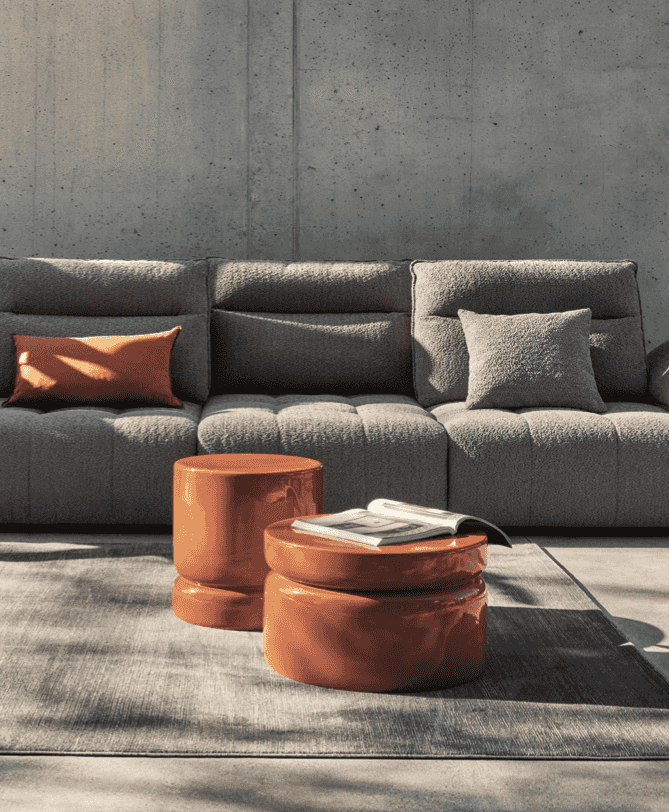 Dark gray CS3467 Equipe Sofa by Calligaris styled with orange accents in a contemporary interior, highlighting its sectional versatility.