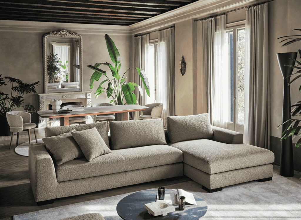 CS348 Sierra Sofa by Calligaris in spacious living-dining area. Italian sectional sofa with chaise lounge offers versatile comfort and timeless style.