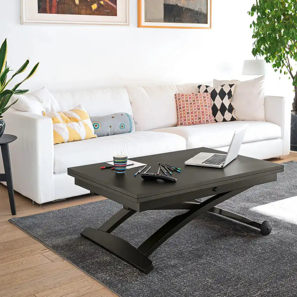 Black multifunctional coffee table with a rectangular top, curved X-shaped base, wheels for mobility, placed in a modern living room
