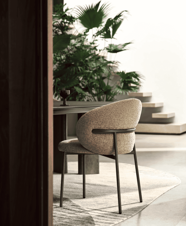 Beige fabric Oleandro dining chair with curved backrest and black metal frame, placed in a contemporary dining area, SKU: CS2222-T2H-P29L