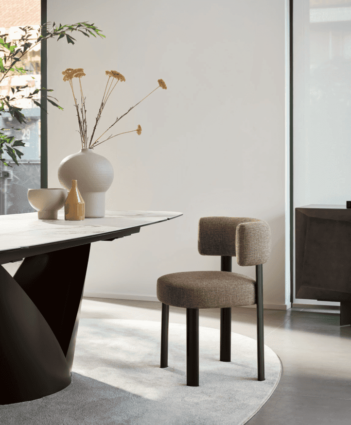 Glen dining chair with brown upholstered seat and backrest, black metal legs, modern design in a contemporary dining room setting