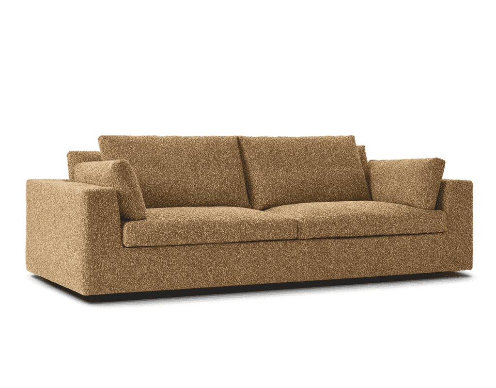 Amon Sofa by Eilersen in golden boucle fabric, highlighting its clean lines, deep seat, and luxurious comfort in a studio setting.