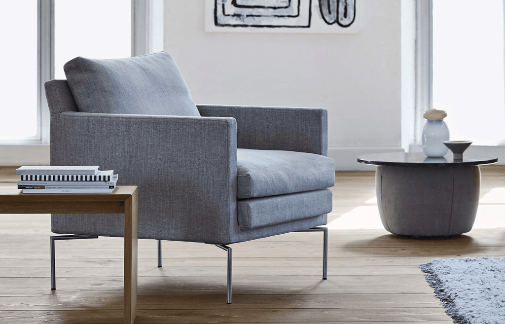 Quick Ship Ashton Chair by Eilersen in grey fabric with slim metal legs, shown in a modern living room at Trade Source Furniture.