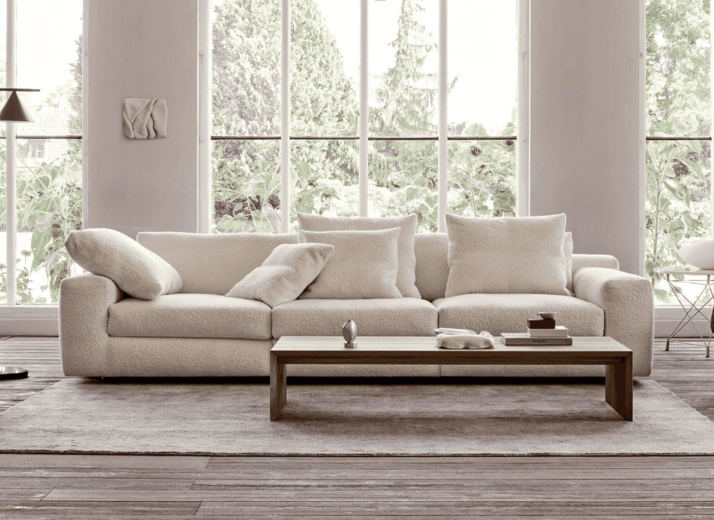 Aton Sofa by Eilersen in white boucle fabric, set in a bright room with large windows, offered at Trade Source Furniture.