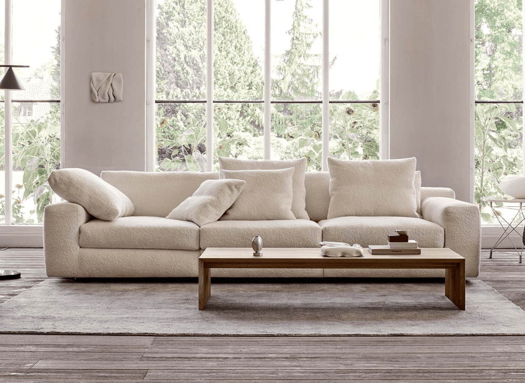 Aton Sofa by Eilersen in white boucle fabric, set in a bright room with large windows, offered at Trade Source Furniture.