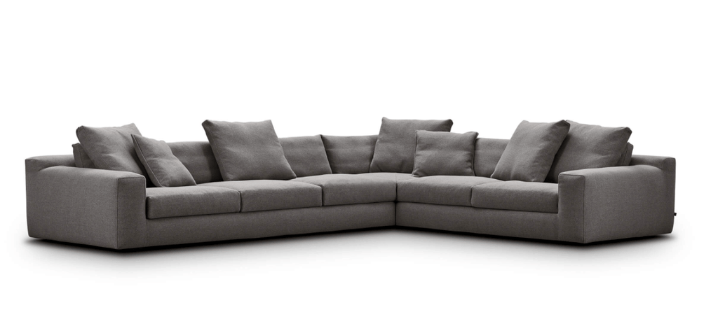 L-shaped Aton Sofa by Eilersen in grey fabric with multiple back cushions, ideal for large living spaces, available at Trade Source Furniture.