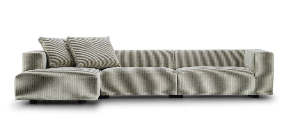 Front view of the Eilersen Baseline Sofa with Chaise in ribbed grey fabric, styled with two angled back cushions for a relaxed look.