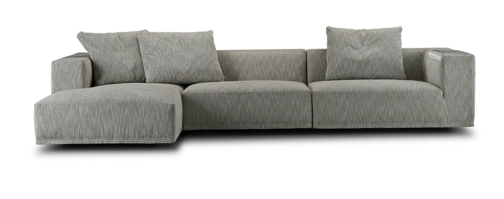 Eilersen Baseline Sofa with Chaise in grey textured fabric, showcasing its low-profile frame and three plush back cushions.