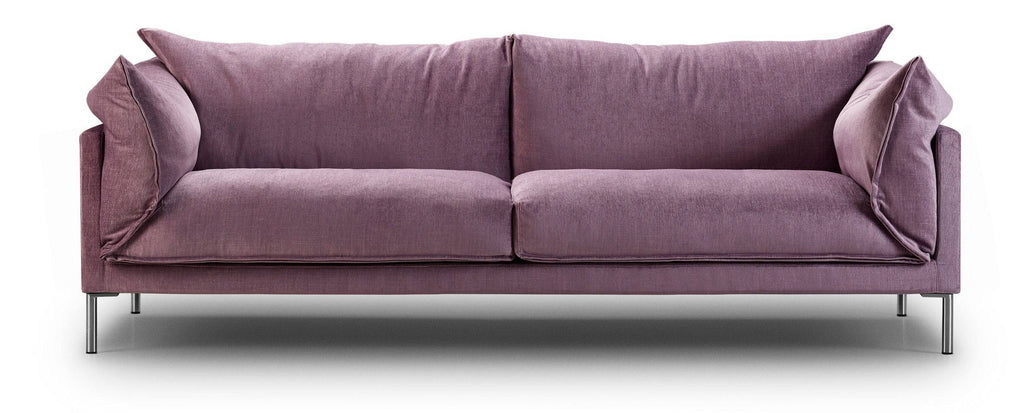 Front view of Butterfly Sofa by Eilersen in lavender fabric, showcasing its plush, inviting design with a balance of structure and softness.