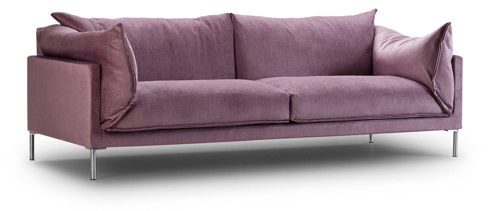Angled view of Butterfly Sofa by Eilersen in lavender fabric, highlighting its soft cushions and slim metal legs for a modern aesthetic.