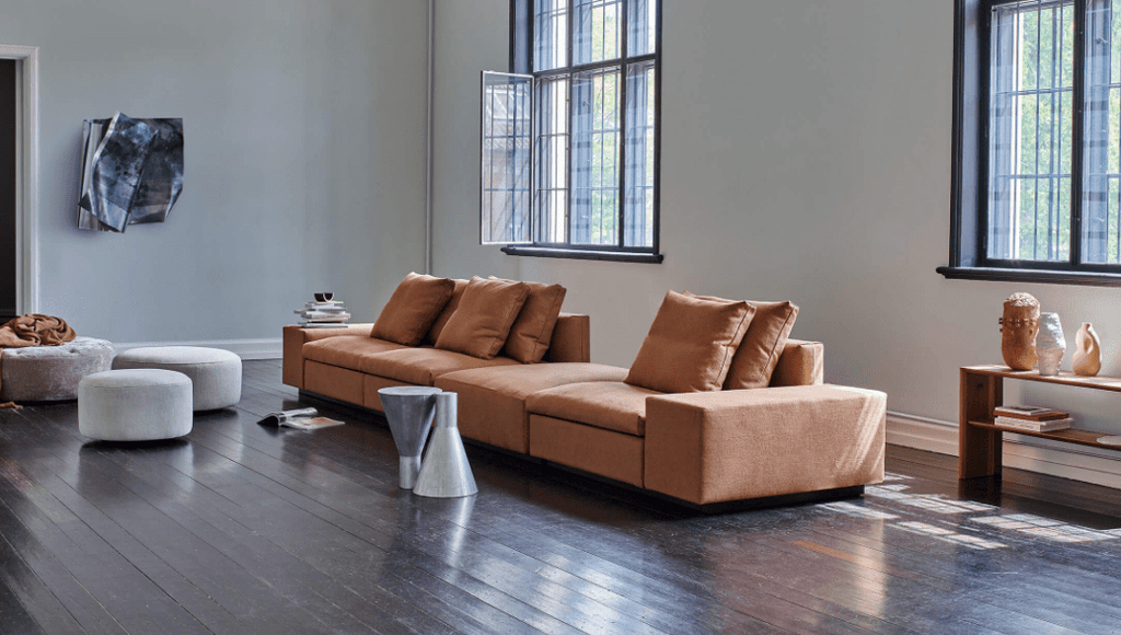 Dacapo Sofa by Eilersen in a spacious interior with accent stools and decor, highlighting its modular design and comfort, offered by Trade Source Furniture.