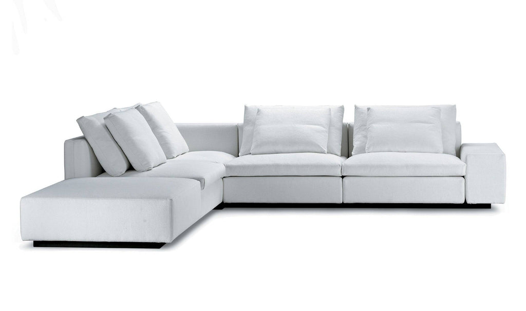 White Dacapo Sectional Sofa by Eilersen in L-shape layout, featuring plush cushions and low armrests, available at Trade Source Furniture.
