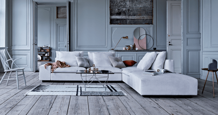White Dacapo Sectional Sofa by Eilersen in a classic interior with wood floors and modern decor, featured at Trade Source Furniture.