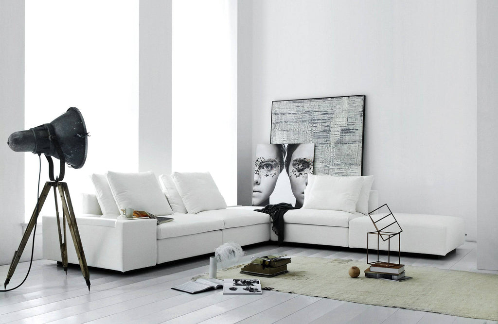 Modern living room with white Dacapo Sofa by Eilersen, styled with artwork and decor, showcasing its modular elegance at Trade Source Furniture.