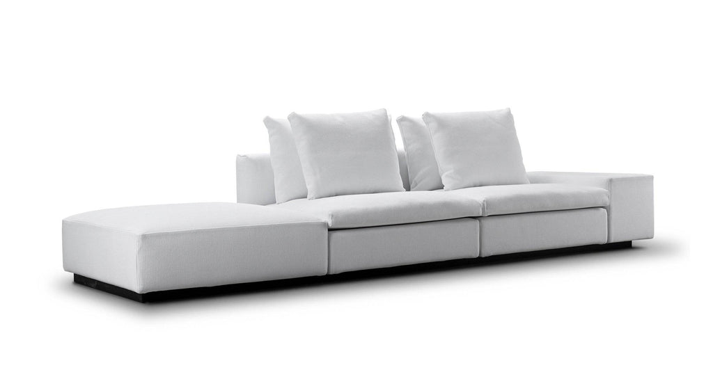 Side view of the white Dacapo Sofa by Eilersen with bumper extension, emphasizing its sleek profile and comfort, available at Trade Source Furniture.