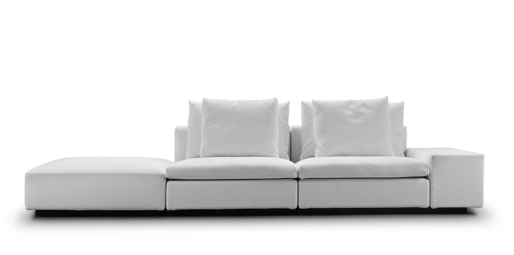 Straight-on view of the white Dacapo Sofa by Eilersen with bumper and armrest, showcasing its modular design, available at Trade Source Furniture.
