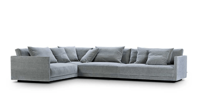 Product image of Eilersen Drop Sofa in blue velvet fabric, featuring low-profile L-shape design and plush back cushions.