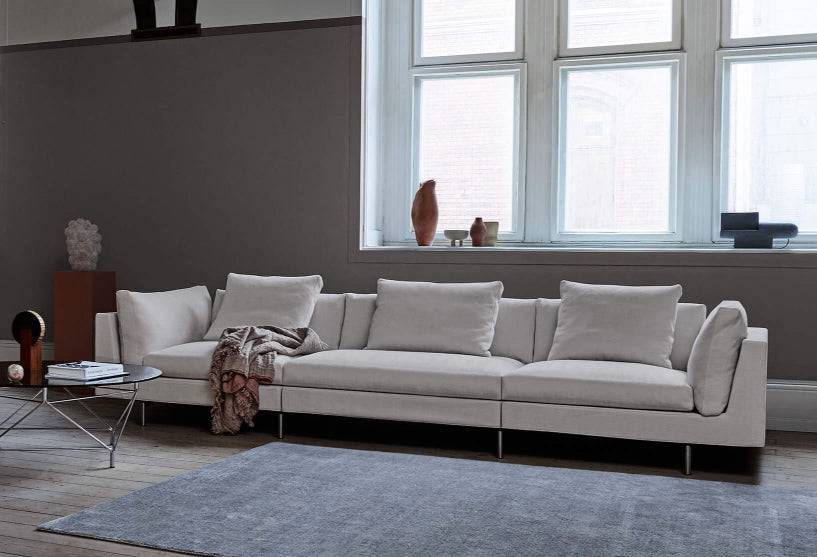 Float High Sectional Sofa by Eilersen in a cozy living space with wood flooring and minimalist decor, emphasizing comfort and style.