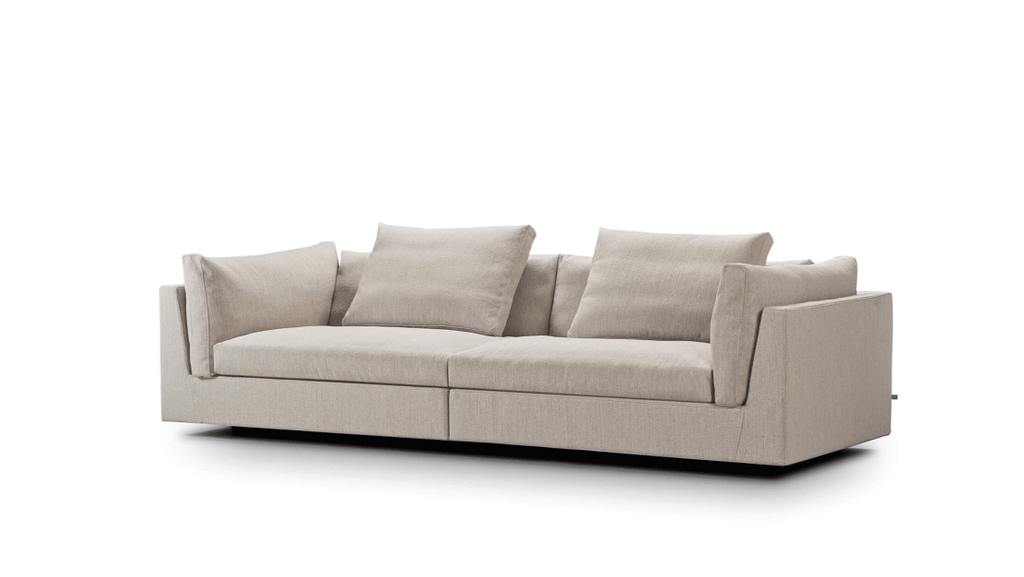 Side view of beige Float Sofa by Eilersen with soft cushions and clean lines. Available in various fabrics at Trade Source Furniture.