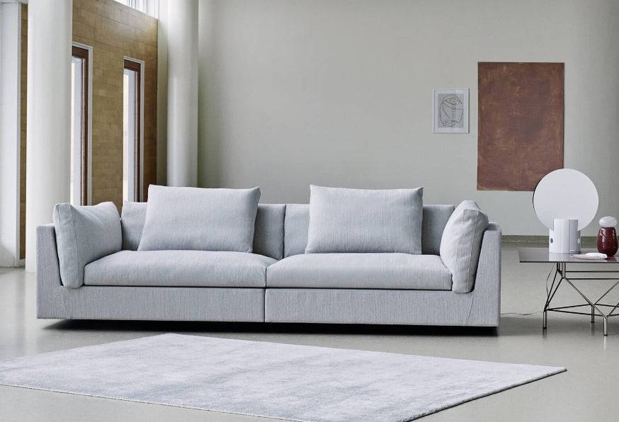 Float Sofa by Eilersen in light grey Tangent 7 fabric, styled in a modern living room at Trade Source Furniture. Minimalist design with plush cushions.