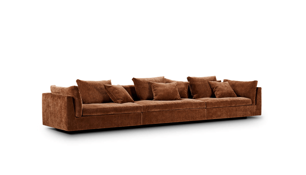 Angled view of rust-colored Float Sofa by Eilersen, showcasing plush seating and modern lines. Offered at Trade Source Furniture.