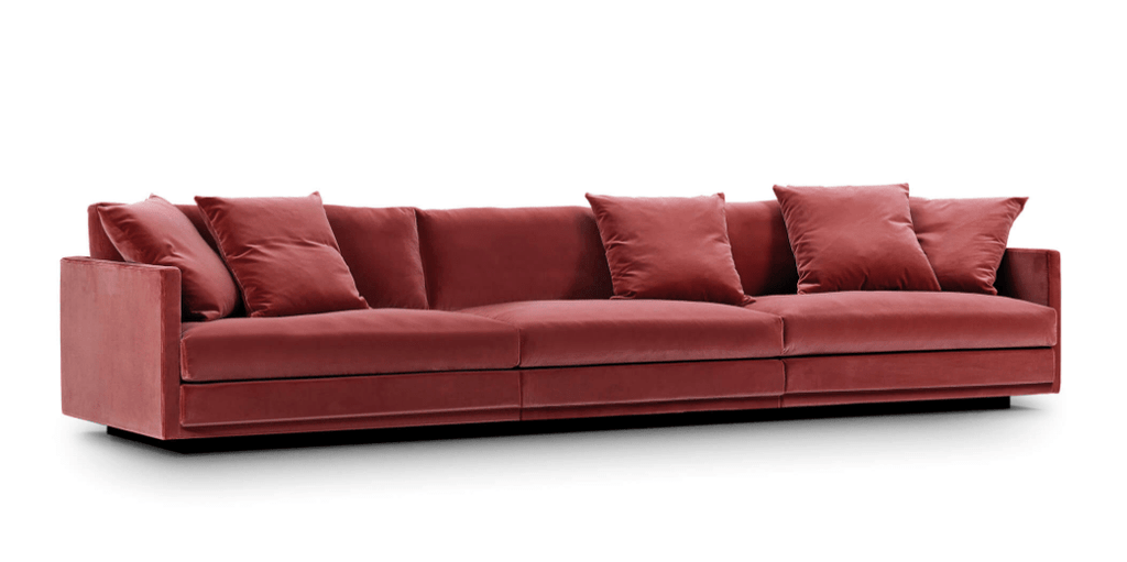 Great Ash Sofa by Eilersen in red velvet, featuring a long modular layout with multiple cushions for luxurious seating.