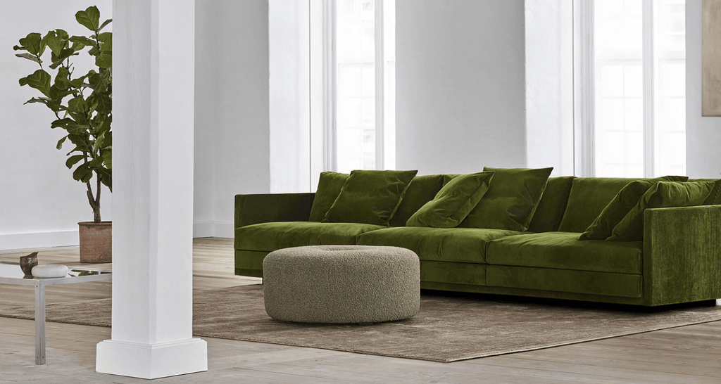 Green Great Ash Sofa by Eilersen styled in a bright living room, paired with a round ottoman and neutral rug for a cozy setup.
