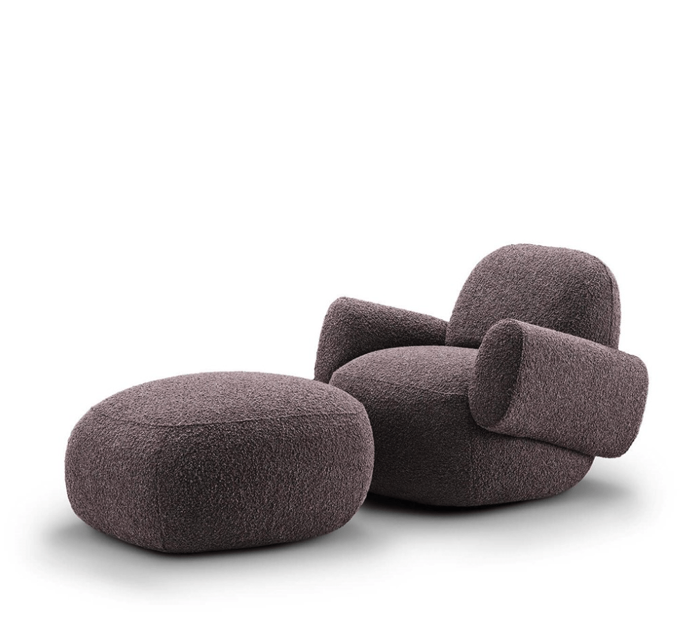 Havana Round Arm Chair and ottoman by Eilersen in dark boucle, offering a cozy and modern seating option.