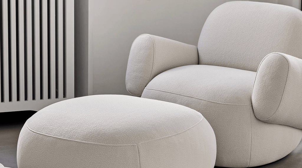 Havana Round Arm Chair and matching ottoman by Eilersen in light boucle, styled in a cozy corner with neutral tones.