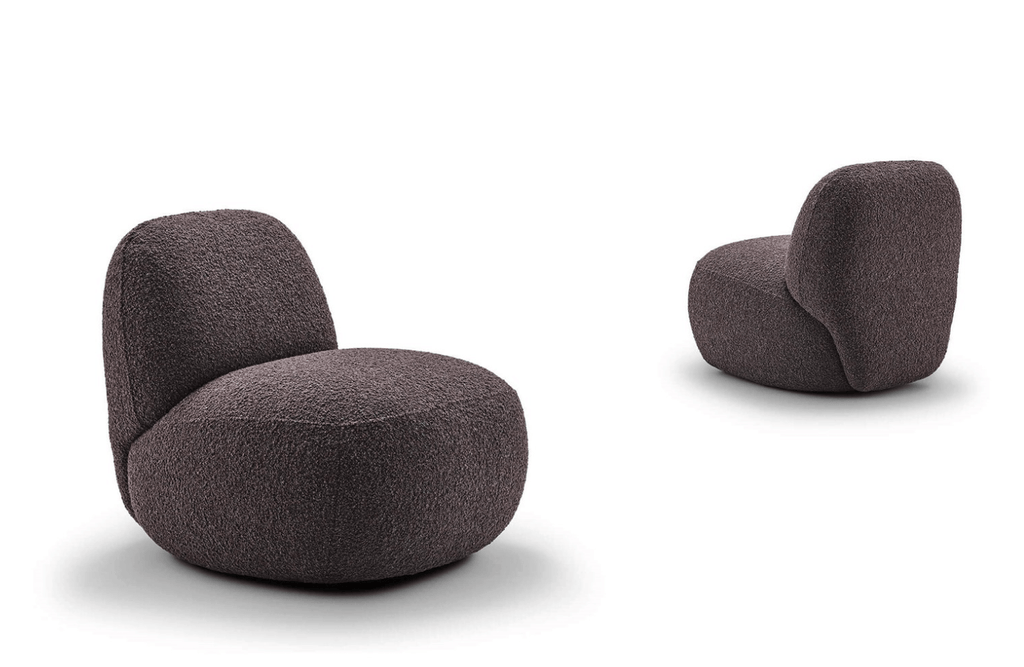 Modern living room with Havana Lounge Chairs by Eilersen in green and yellow velvet, styled with a glass coffee table.