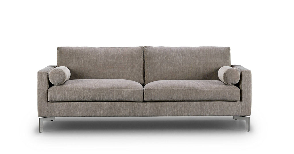 Front view of the Quick Ship Lift Sofa by Eilersen in beige fabric with dual round pillows, perfect for contemporary living rooms.