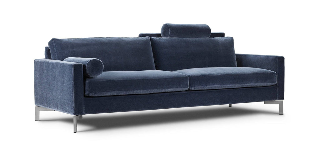 Side angle of the Quick Ship Lift Sofa by Eilersen in deep blue velvet, featuring sleek metal legs and plush cushions.