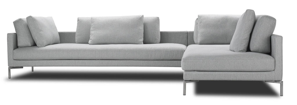 Front view of Eilersen Plano Sectional Sofa in light grey, highlighting its spacious seating and plush back cushions.